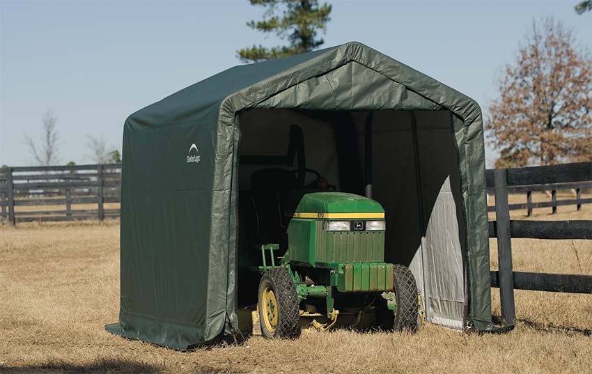 Portable outdoor shed storing tractor