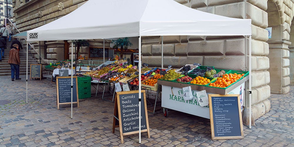 Farmers market in the city with a Quik Shade Commercial Series canopy