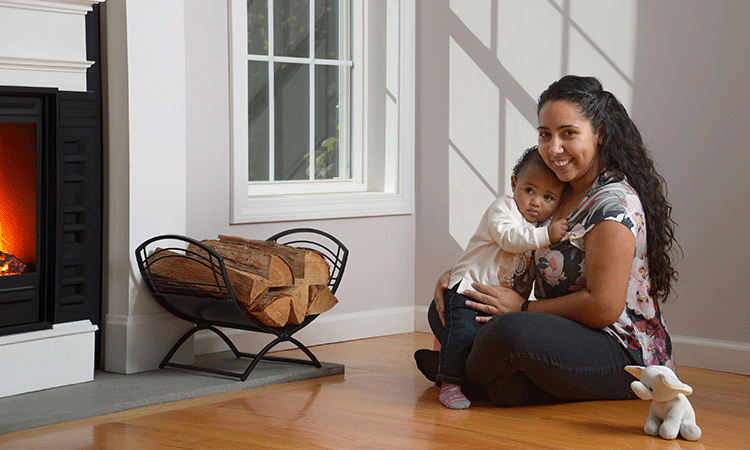 Woman and baby in front of a fireplace