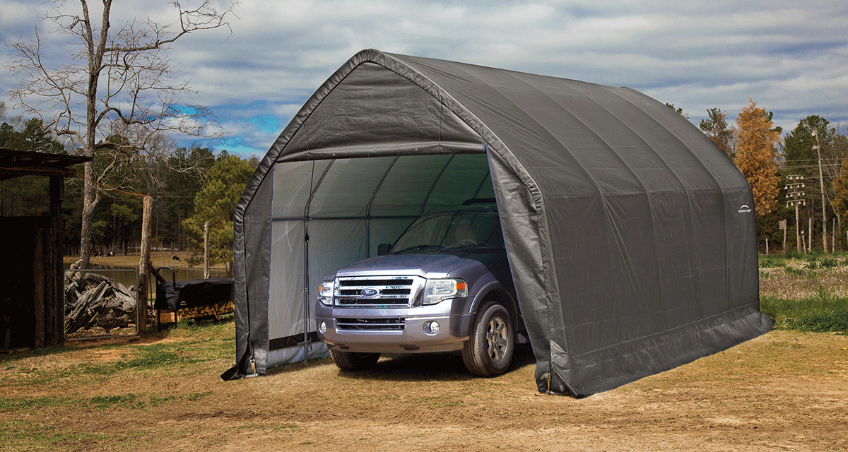 ShelterLogic garage in a field with a truck parked inside